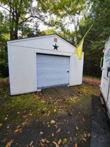 Southern Maine Power and Pressure Washing. Garage, after cleaning, with yellow flag and Nexgen truck to right.